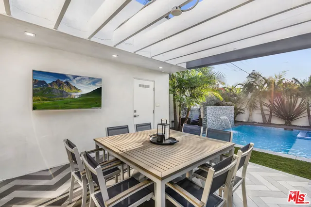a view of a dining room with furniture a rug and wooden floor