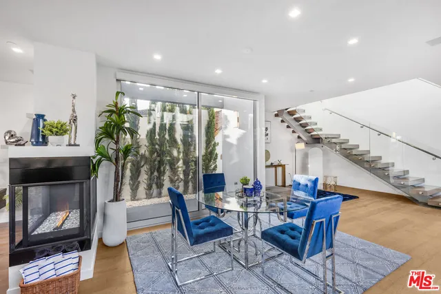 a living room with fireplace furniture and a potted plant