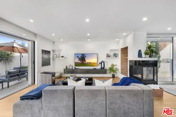 a living room with fireplace furniture and a flat screen tv