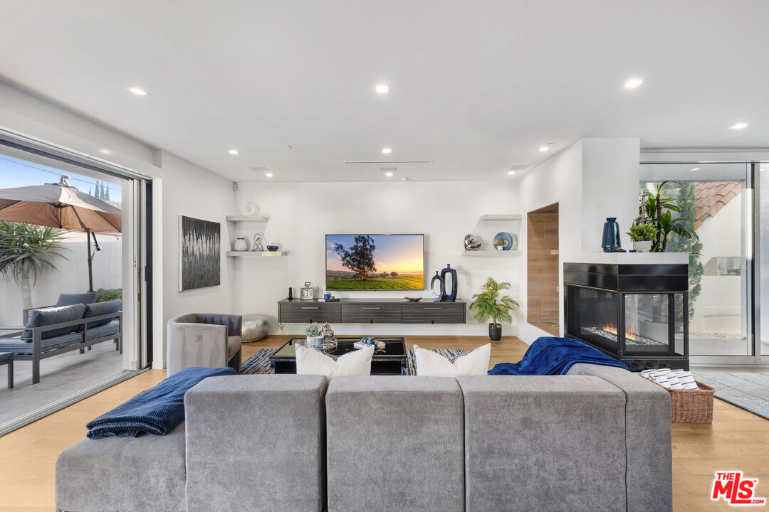 6410 Lindenhurst Avenue Los Angeles, CA 90048 - Photo 8 of 39 a living room with fireplace furniture and a flat screen tv