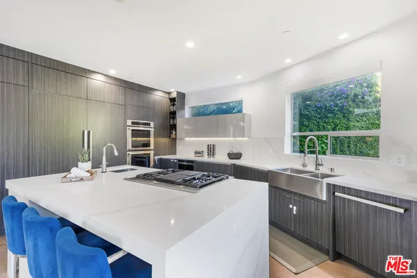 a kitchen with a sink a stove a refrigerator and a oven