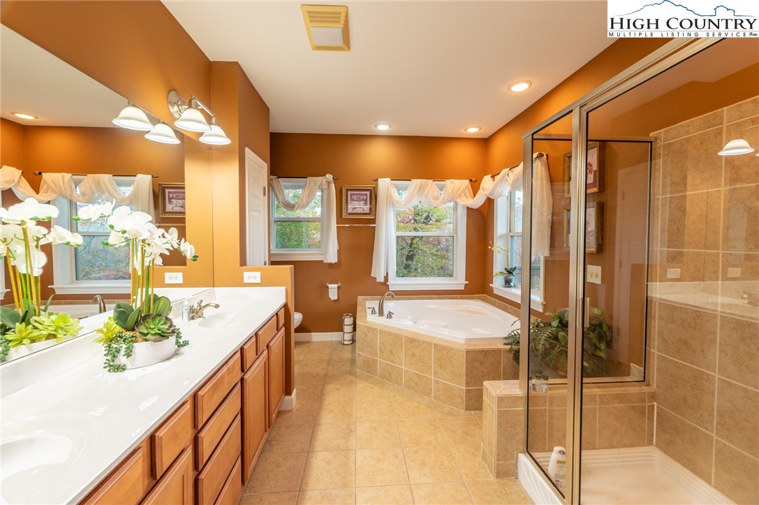 309 Pinnacle Ridge Road Beech Mountain, NC 28604 - Photo 23 of 45 a spacious bathroom with a double vanity sink and a large mirror