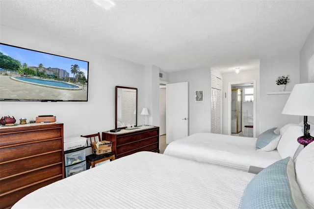 a bathroom with a double vanity sink a mirror and a shower