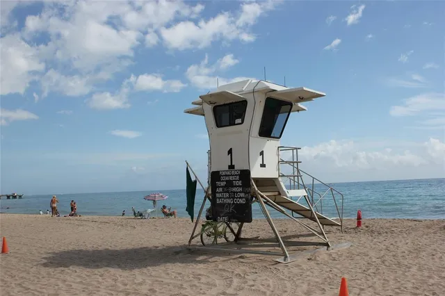 a patio with swimming pool table and chairs