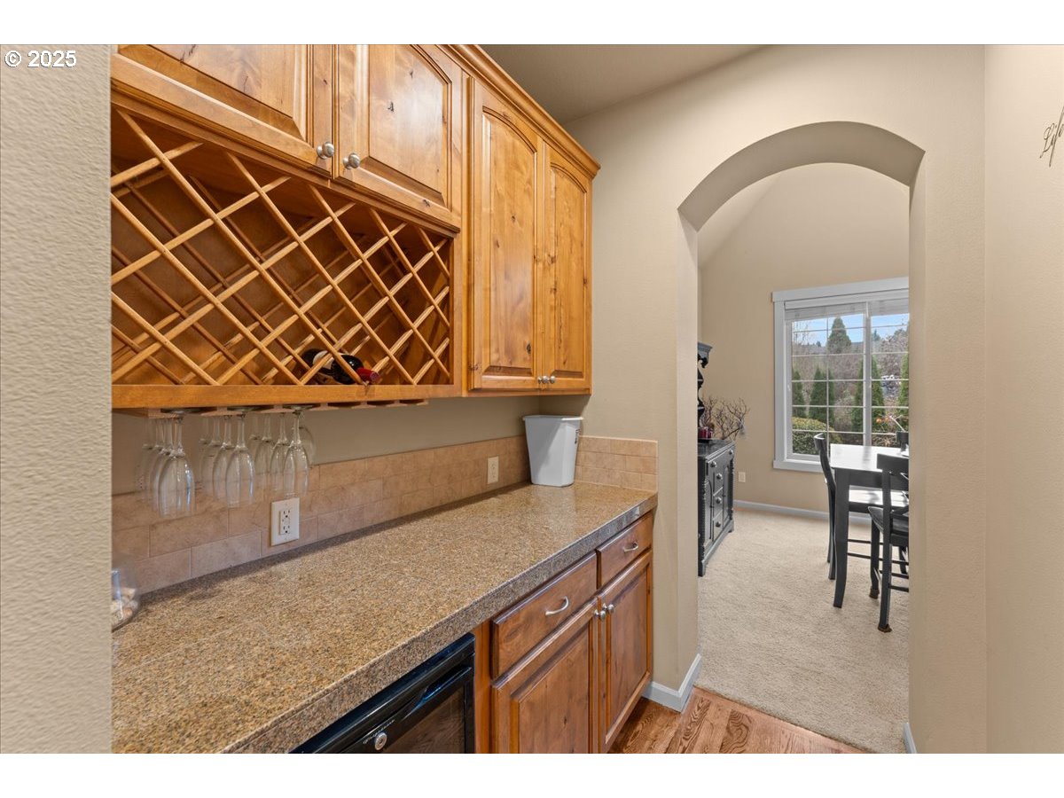15485 Southwest Willamette Valley Court Beaverton, OR 97007 - Photo 13 of 48 a view of kitchen island with wooden cabinets