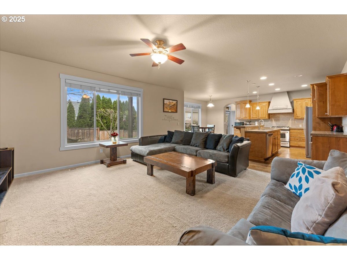 15485 Southwest Willamette Valley Court Beaverton, OR 97007 - Photo 16 of 48 a living room with furniture and a kitchen view
