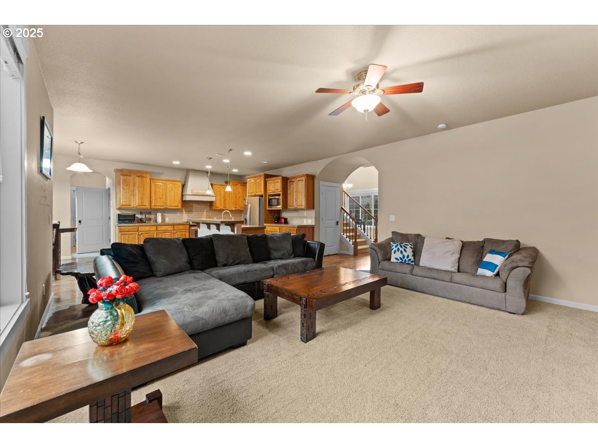 15485 Southwest Willamette Valley Court Beaverton, OR 97007 - Photo 17 of 48 a living room with furniture and a chandelier