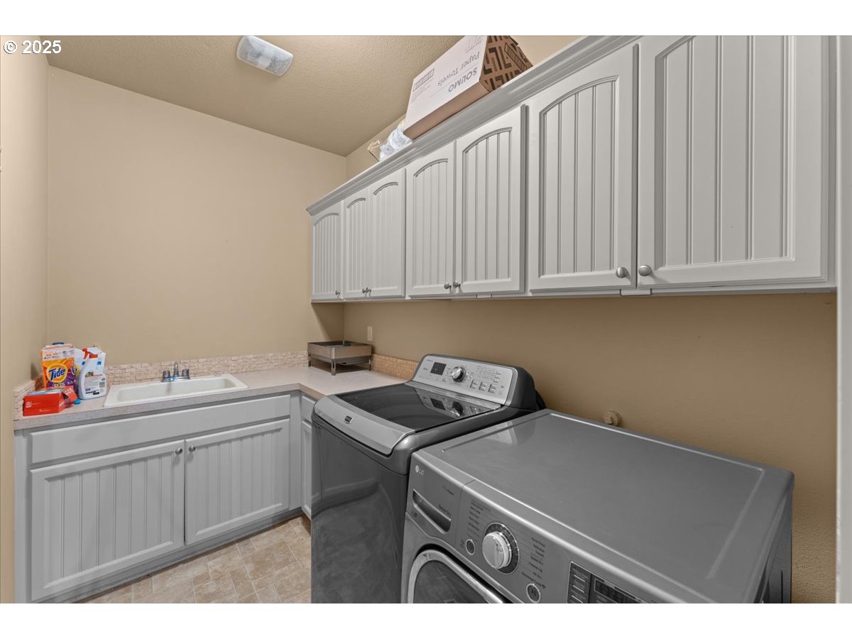 15485 Southwest Willamette Valley Court Beaverton, OR 97007 - Photo 19 of 48 a utility room with sink dryer and washer