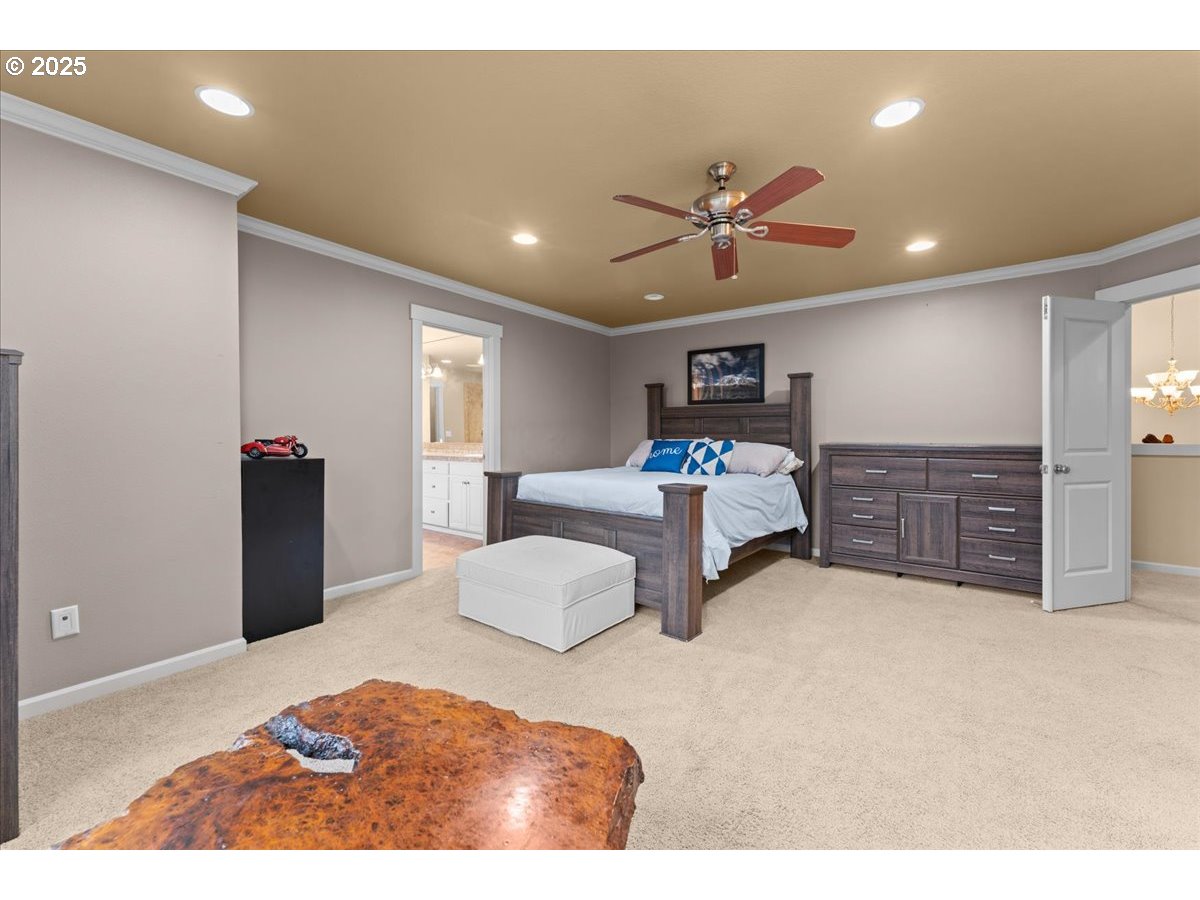 15485 Southwest Willamette Valley Court Beaverton, OR 97007 - Photo 21 of 48 a bedroom with a bed and a chandelier