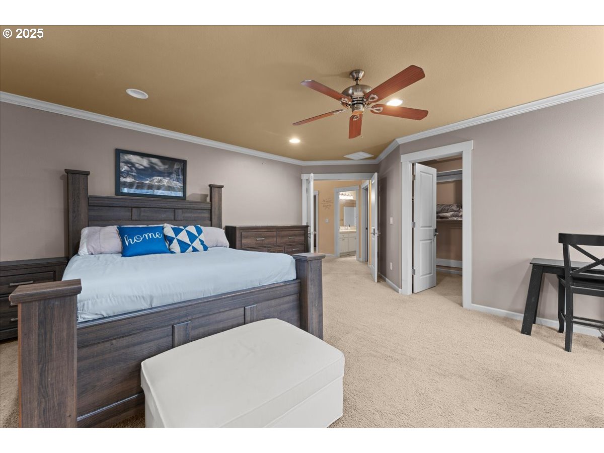 15485 Southwest Willamette Valley Court Beaverton, OR 97007 - Photo 22 of 48 a bedroom with a bed and a chandelier