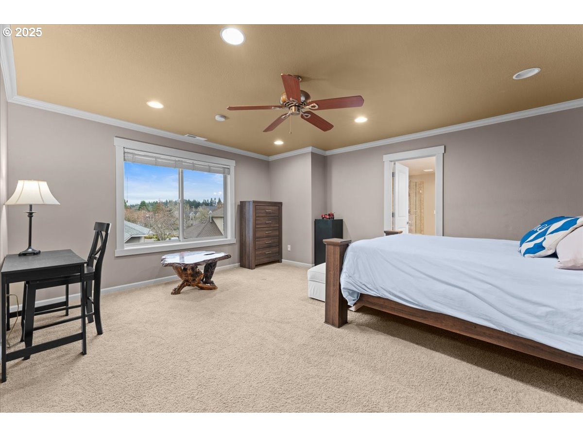 15485 Southwest Willamette Valley Court Beaverton, OR 97007 - Photo 23 of 48 a bed room with a bed and a chandelier