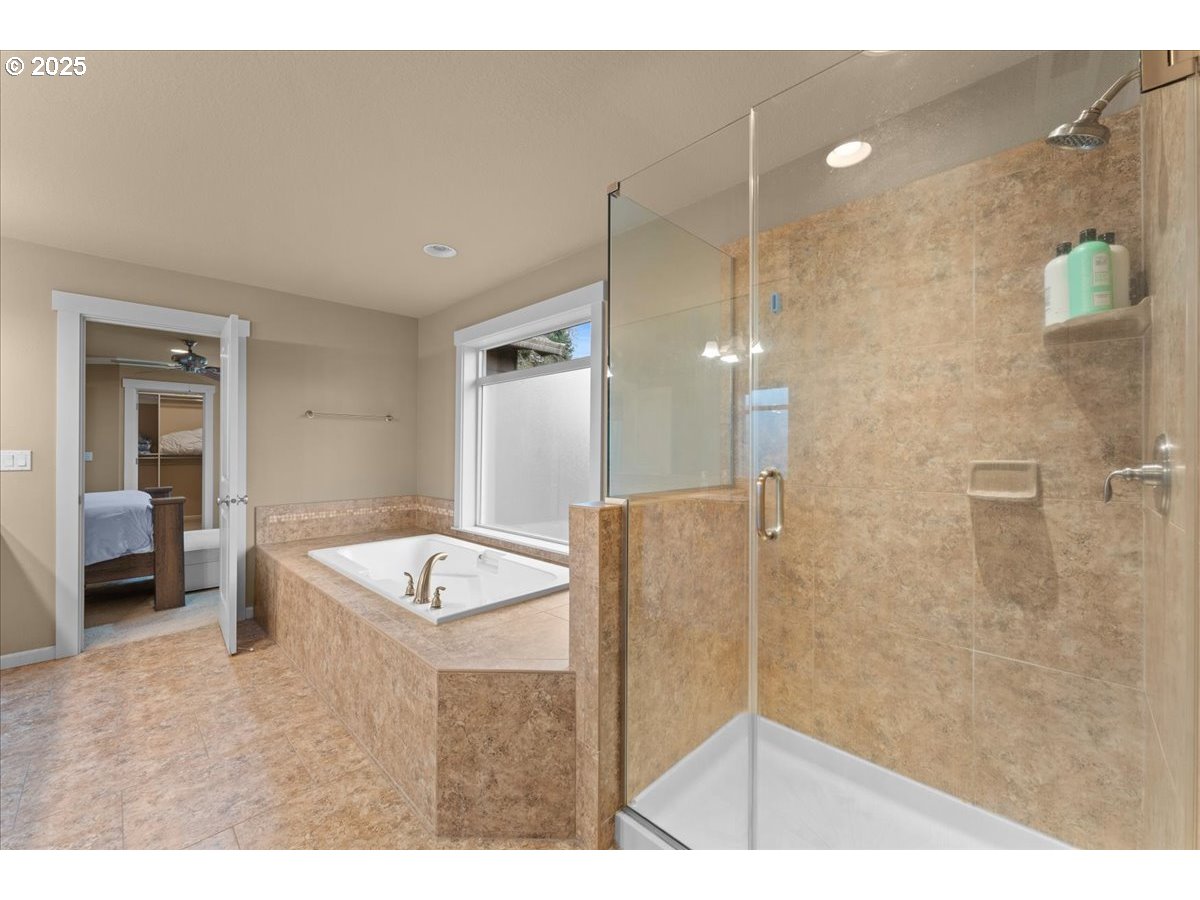 15485 Southwest Willamette Valley Court Beaverton, OR 97007 - Photo 27 of 48 a bathroom with a granite countertop sink a mirror and shower