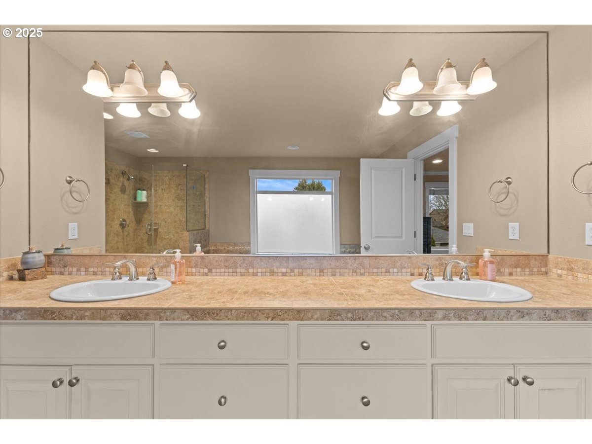 15485 Southwest Willamette Valley Court Beaverton, OR 97007 - Photo 28 of 48 a bathroom with a sink mirror and vanity