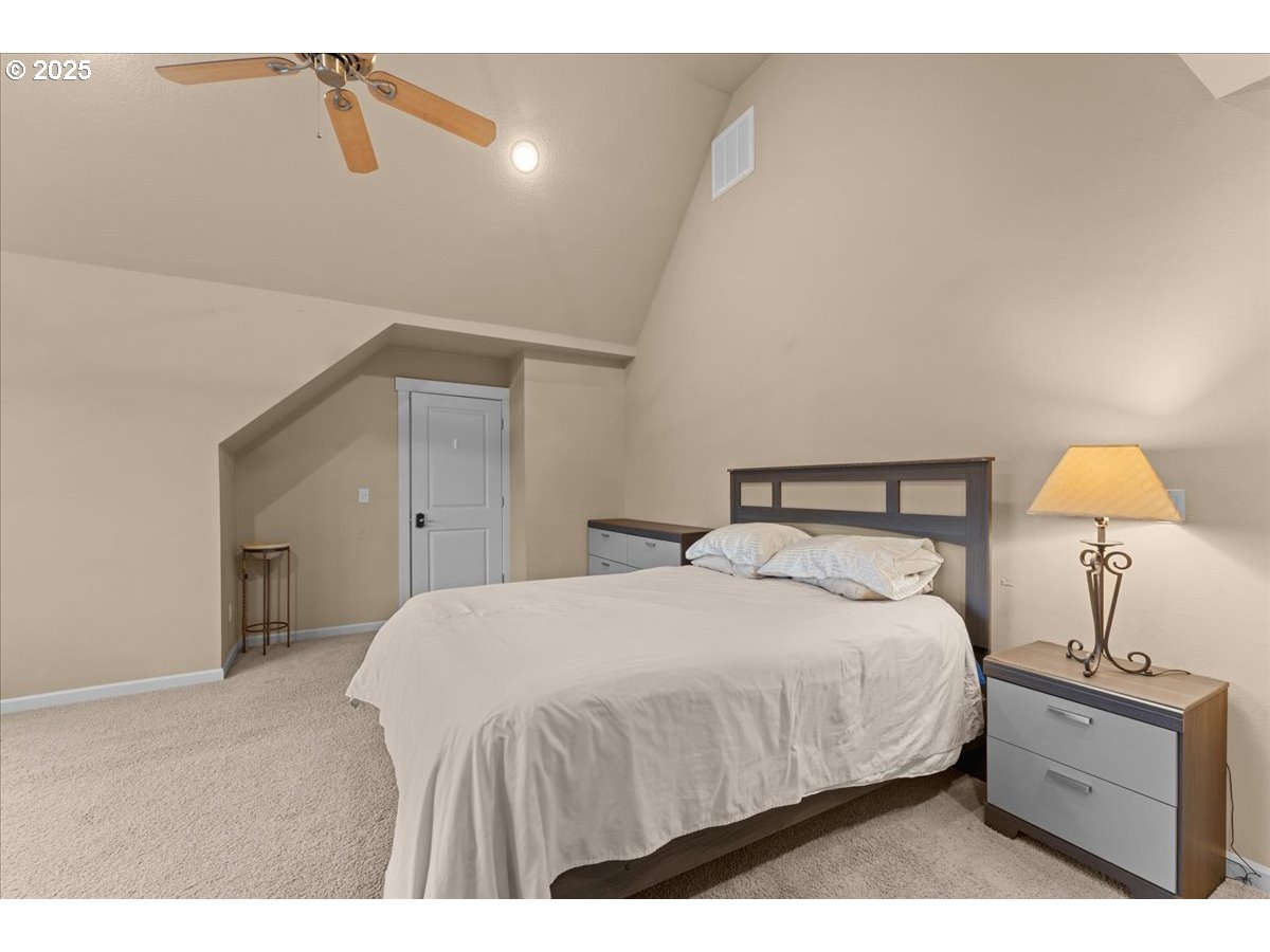 15485 Southwest Willamette Valley Court Beaverton, OR 97007 - Photo 30 of 48 a bedroom with a bed and lamp