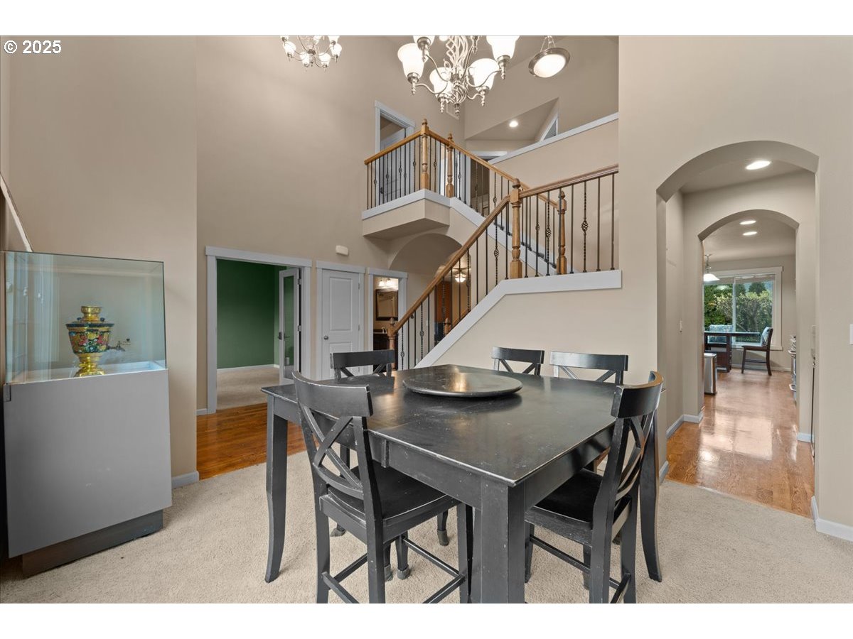 15485 Southwest Willamette Valley Court Beaverton, OR 97007 - Photo 3 of 48 a view of a dining room with furniture and a chandelier