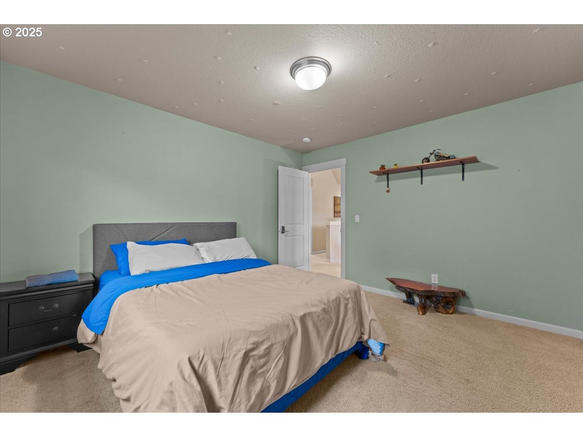 15485 Southwest Willamette Valley Court Beaverton, OR 97007 - Photo 33 of 48 a bedroom with a bed and a dresser