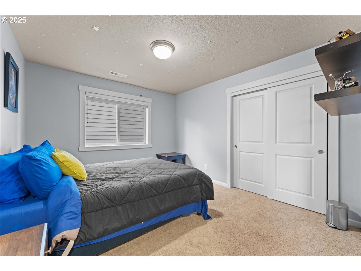 15485 Southwest Willamette Valley Court Beaverton, OR 97007 - Photo 35 of 48 a bedroom with a bed and a television