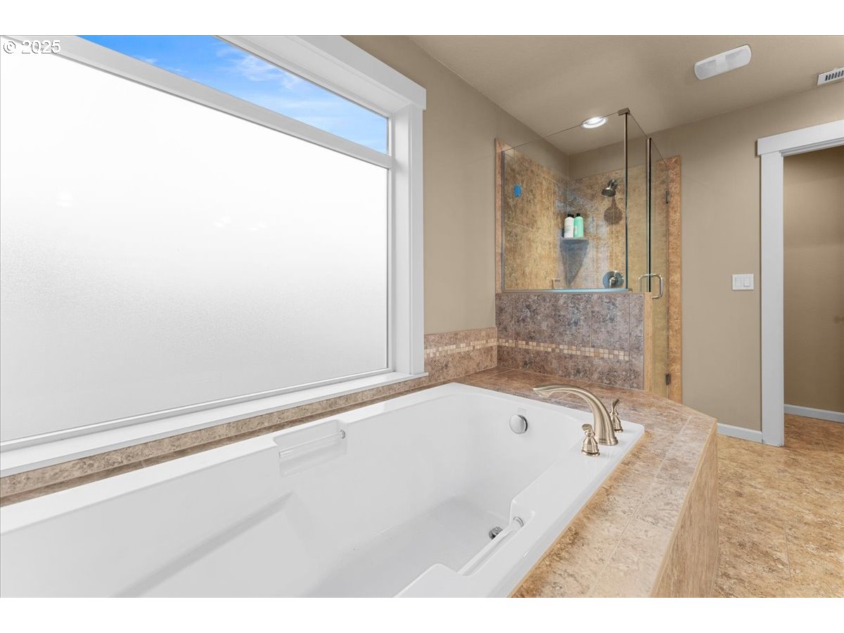 15485 Southwest Willamette Valley Court Beaverton, OR 97007 - Photo 38 of 48 a bathroom with a bathtub and a shower