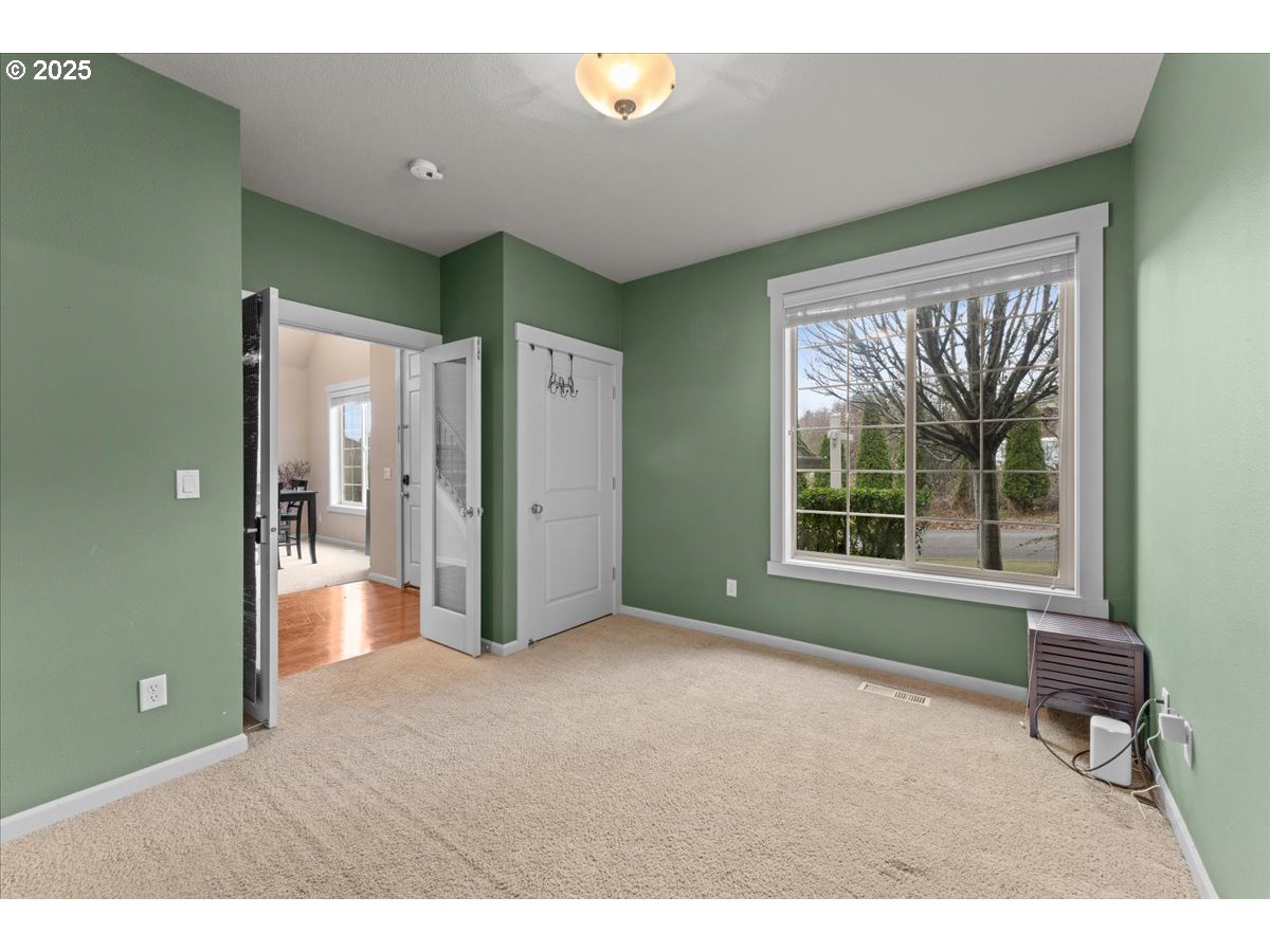 15485 Southwest Willamette Valley Court Beaverton, OR 97007 - Photo 40 of 48 a living room with a large window and a chandelier