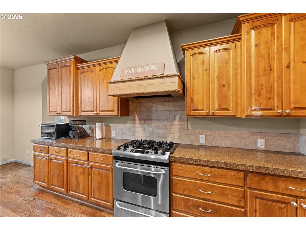 15485 Southwest Willamette Valley Court Beaverton, OR 97007 - Photo 9 of 48 a kitchen with stainless steel appliances granite countertop a stove a sink and dishwasher