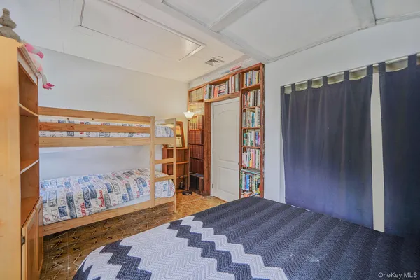 a view of a bedroom with furniture and window