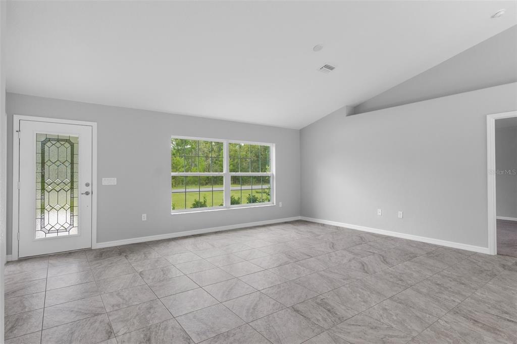 16375 Kakawi Road Brooksville, FL 34614 - Photo 5 of 30 a view of an empty room with a window