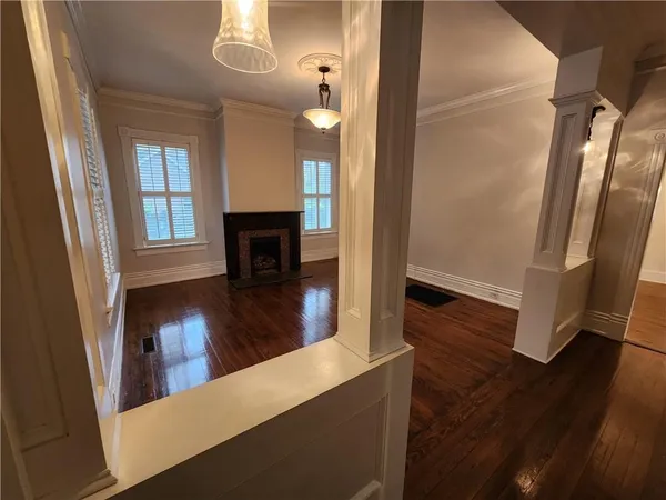a view of a room with wooden floor and window