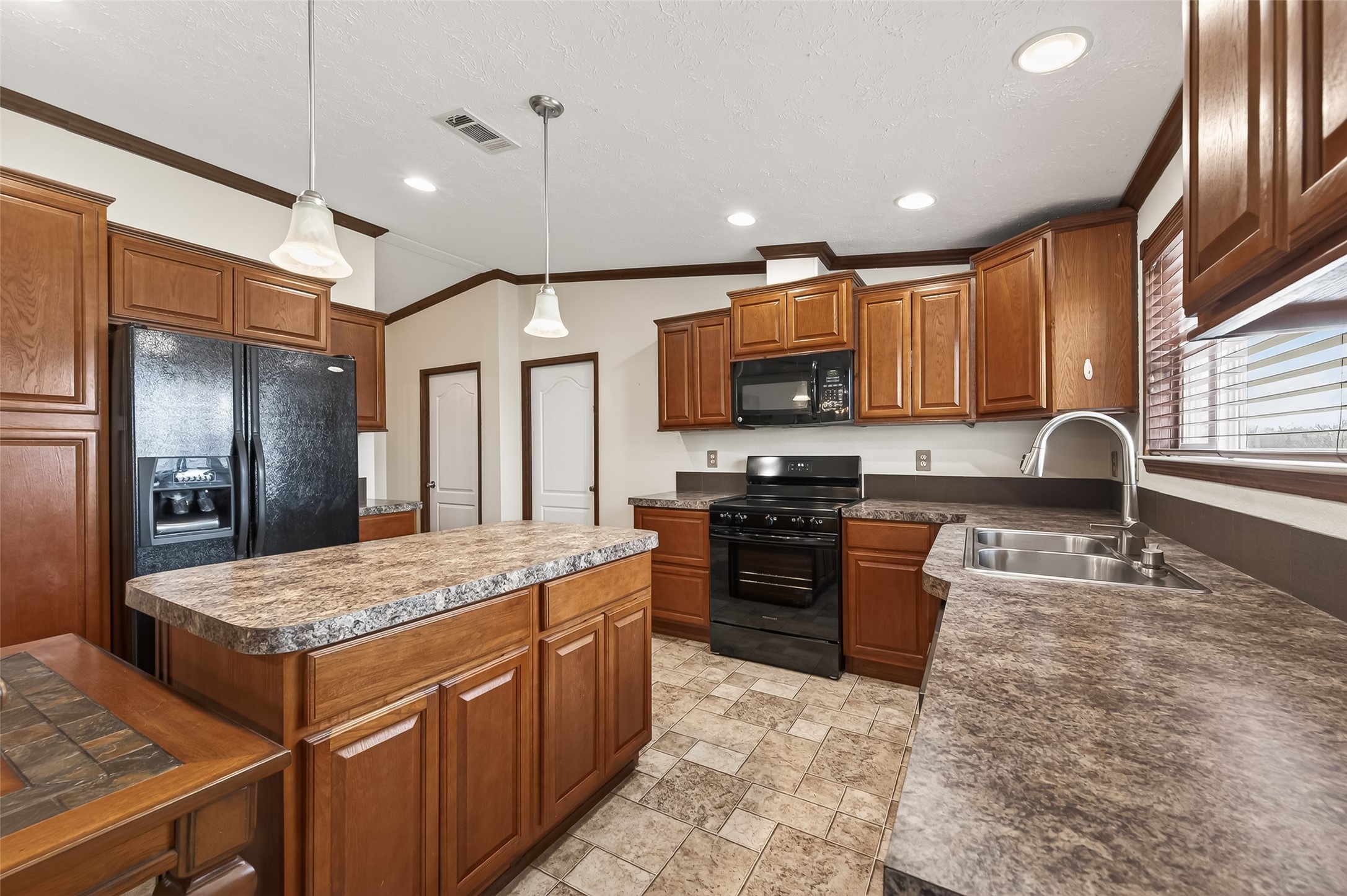 9820 Oberrender Road Needville, TX 77461 - Photo 17 of 34 Large Kitchen with Island and Sliding Doors overlooking acreage
