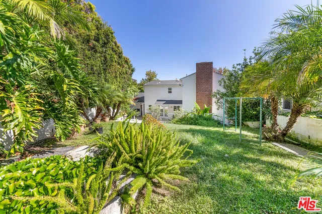 a view of a garden with a building in the background