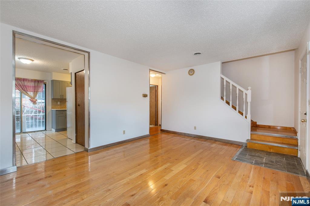 553 Ocean Avenue Jersey City, NJ 07305 - Photo 1 of 27 a view of an empty room with wooden floor and entryway