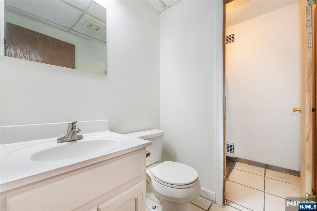 553 Ocean Avenue Jersey City, NJ 07305 - Photo 11 of 27 a bathroom with a sink toilet and a mirror