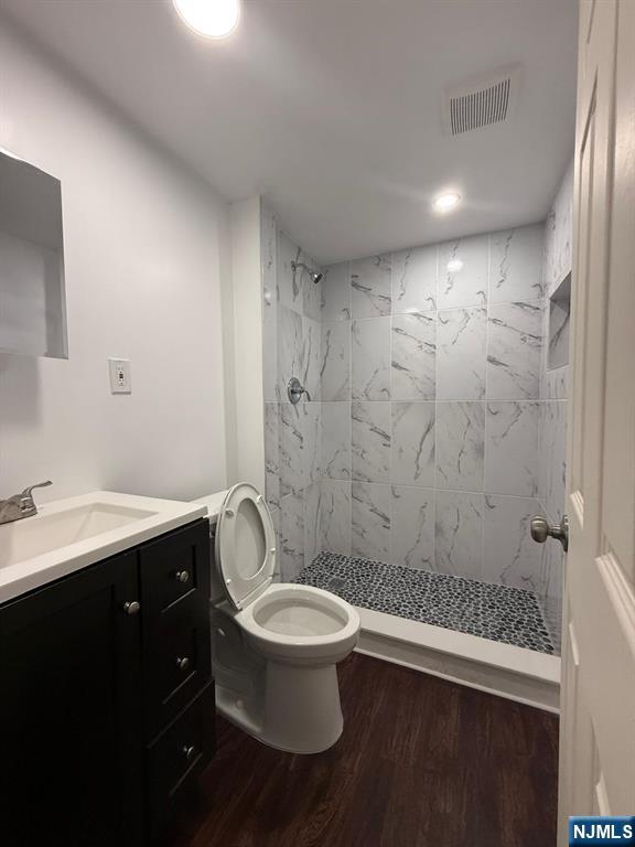 553 Ocean Avenue Jersey City, NJ 07305 - Photo 12 of 27 a bathroom with a sink a toilet a shower and a mirror