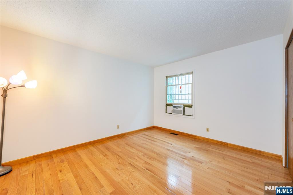 553 Ocean Avenue Jersey City, NJ 07305 - Photo 16 of 27 a view of empty room with wooden floor and fan