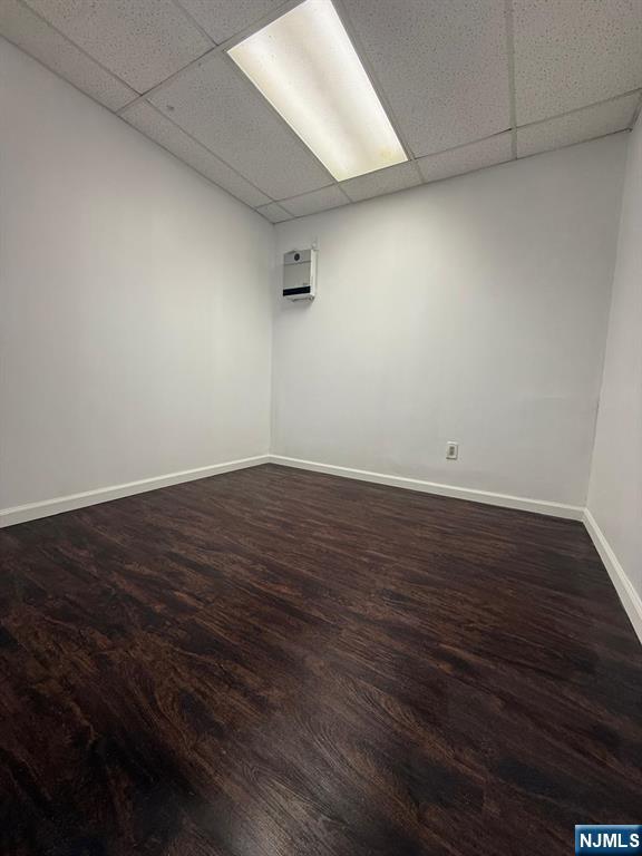 553 Ocean Avenue Jersey City, NJ 07305 - Photo 19 of 27 an empty room with wooden floor and windows