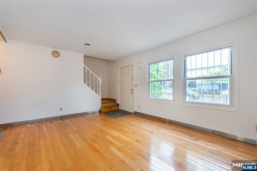 553 Ocean Avenue Jersey City, NJ 07305 - Photo 2 of 27 a view of an empty room with wooden floor and a window