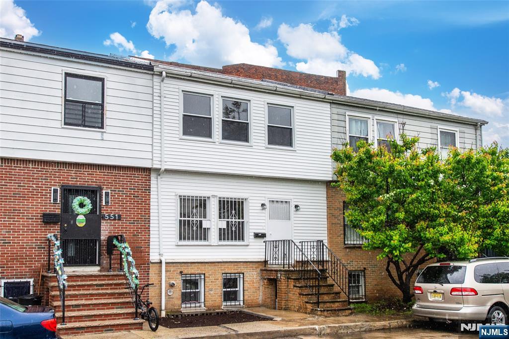 553 Ocean Avenue Jersey City, NJ 07305 - Photo 27 of 27 a front view of a residential apartment building with a yard