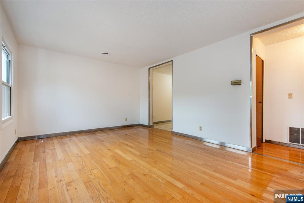 553 Ocean Avenue Jersey City, NJ 07305 - Photo 4 of 27 a view of room with window and wooden floor