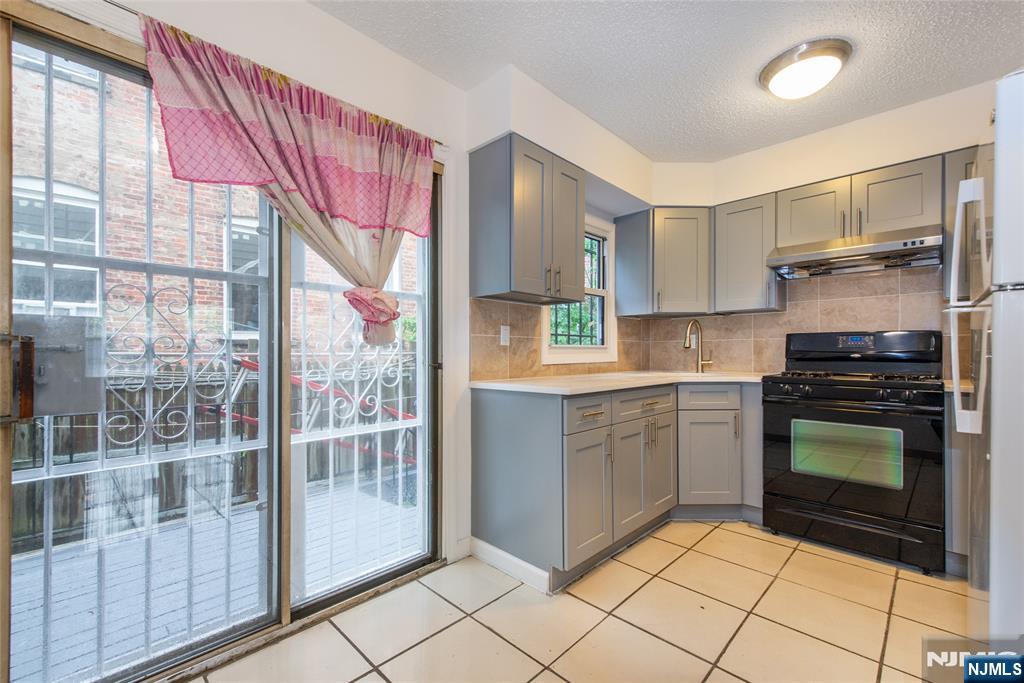 553 Ocean Avenue Jersey City, NJ 07305 - Photo 5 of 27 a kitchen with a sink cabinets and appliances