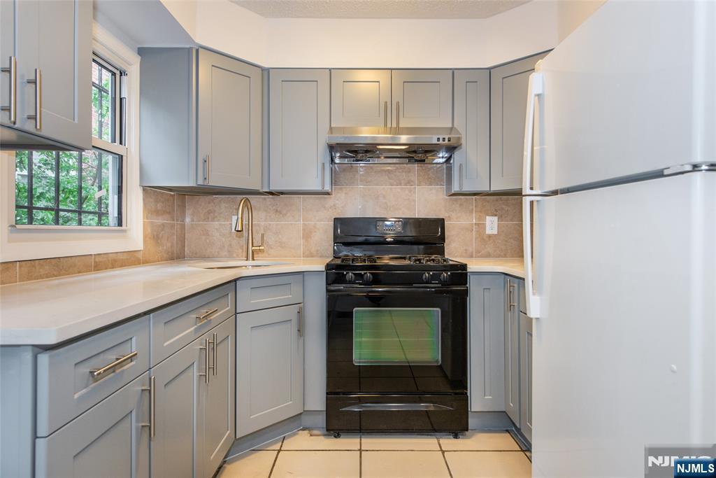 553 Ocean Avenue Jersey City, NJ 07305 - Photo 6 of 27 a kitchen with appliances cabinets and a window
