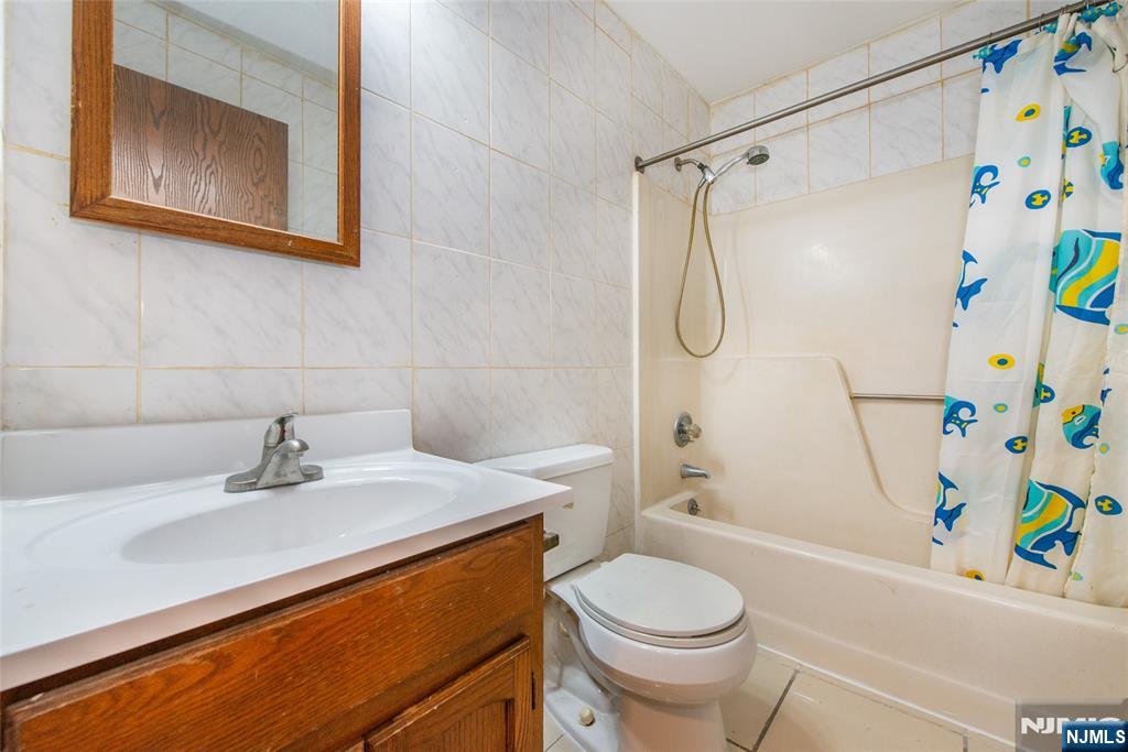 553 Ocean Avenue Jersey City, NJ 07305 - Photo 9 of 27 a bathroom with a sink a toilet and shower