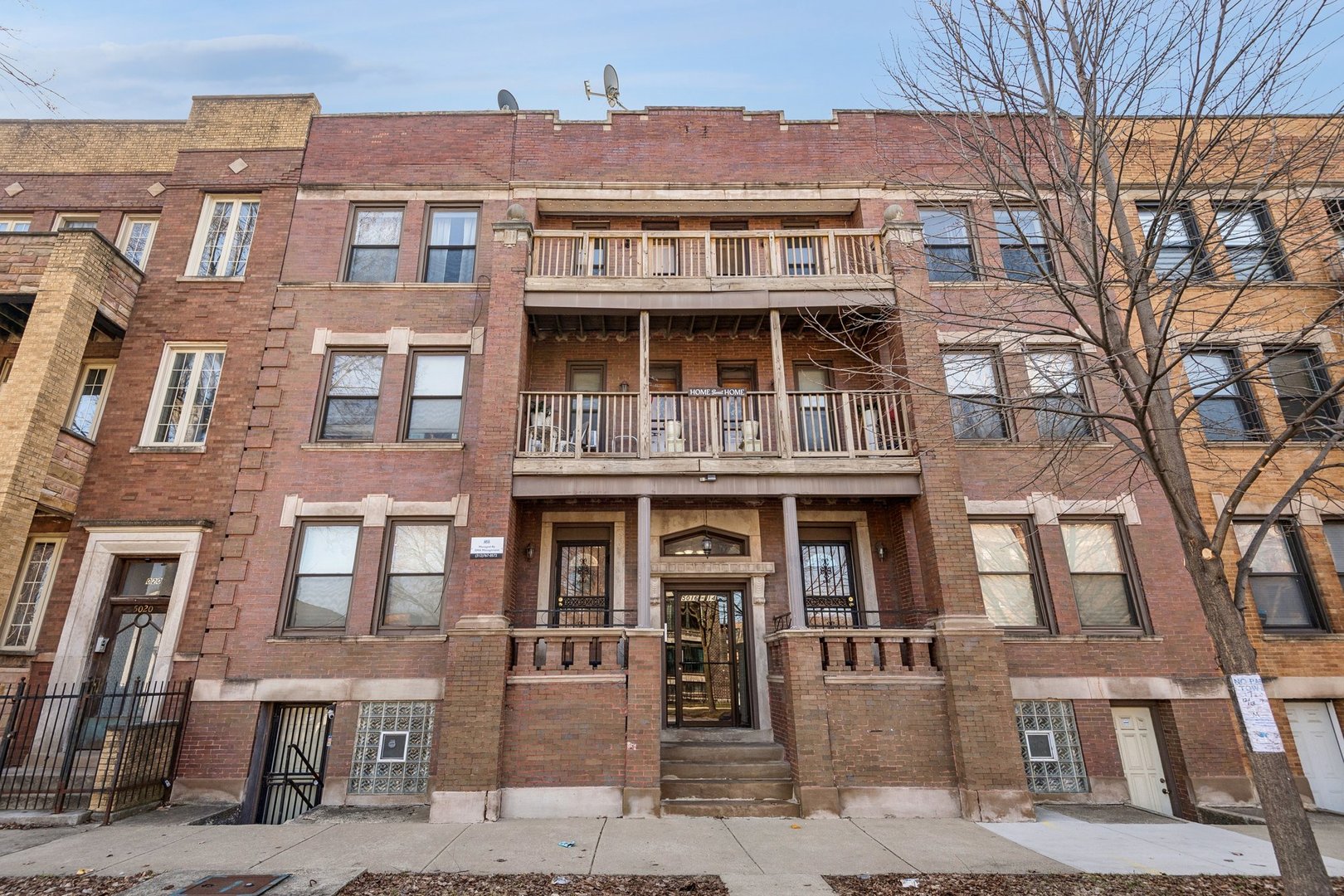 5016 South Prairie Avenue, Unit 1 Chicago, IL 60615 - Photo 1 of 10 a front view of a residential apartment building with a yard