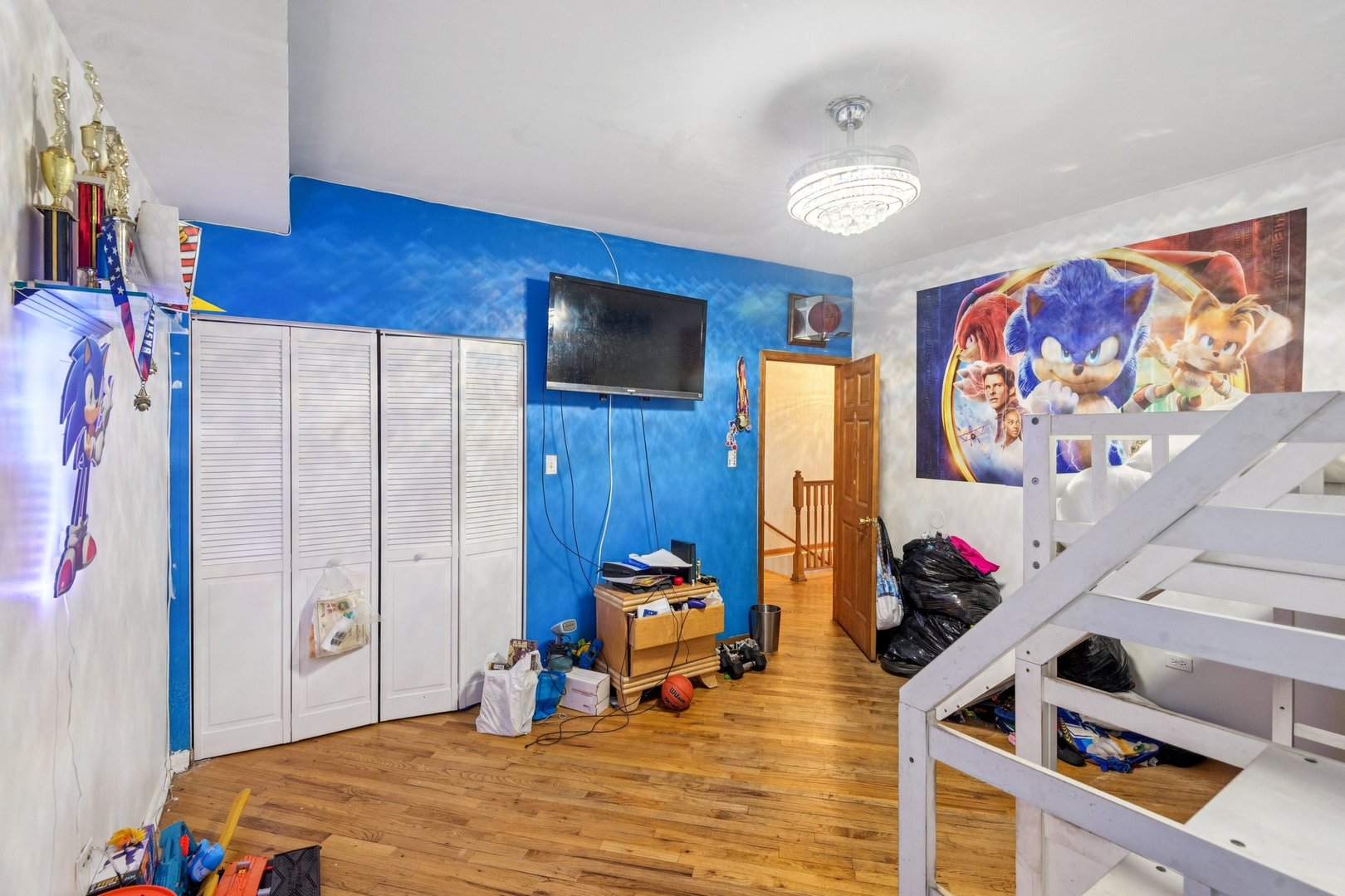 5016 South Prairie Avenue, Unit 1 Chicago, IL 60615 - Photo 8 of 10 a bed room with a bed and a television