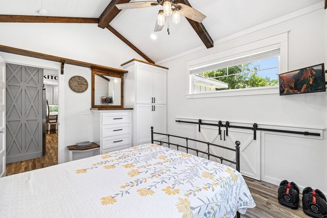 a bedroom with a bed a window and dresser