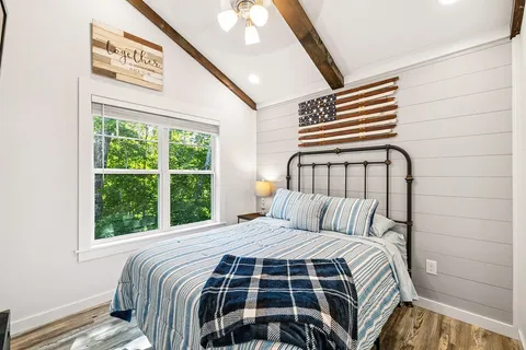 a bedroom with a bed and a window