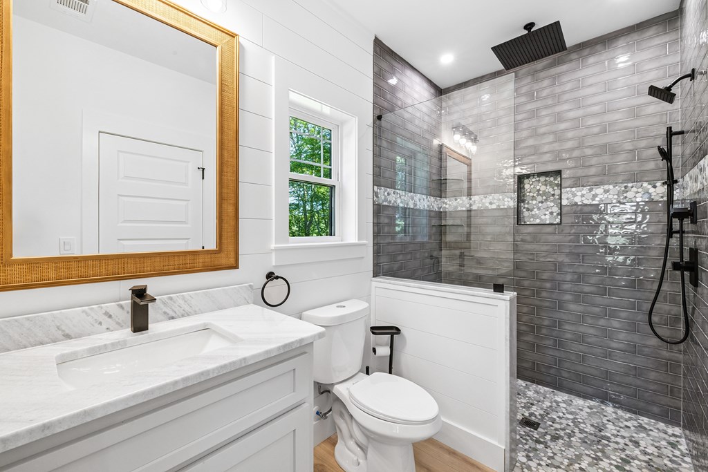 60 Buckeye Branch Road Morganton, GA 30560 - Photo 16 of 51 a bathroom with a sink toilet a mirror and shower