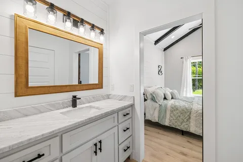 a en suite bathroom with a double vanity sink and a mirror