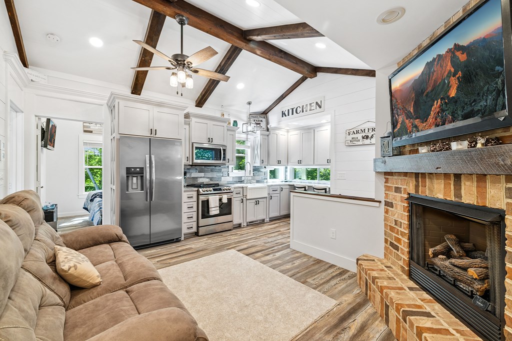 60 Buckeye Branch Road Morganton, GA 30560 - Photo 22 of 51 a kitchen with stainless steel appliances kitchen island granite countertop a refrigerator a stove and a sink with cabinets