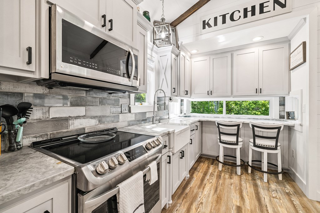 60 Buckeye Branch Road Morganton, GA 30560 - Photo 24 of 51 a kitchen with a stove a sink and a microwave