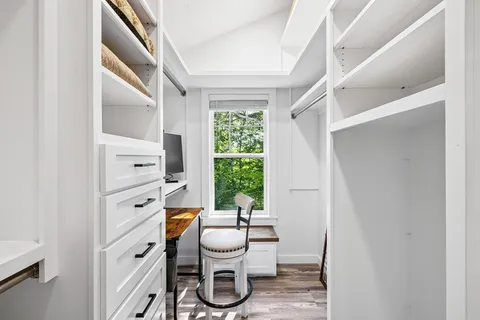 a bathroom with a toilet a sink and a window