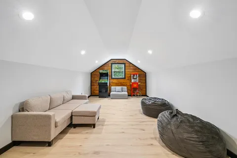 a living room with furniture a rug and a window